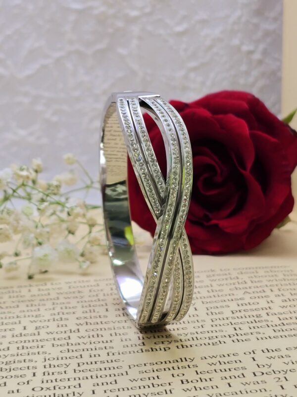 Elegant crystal-encrusted crossover bangle bracelet.