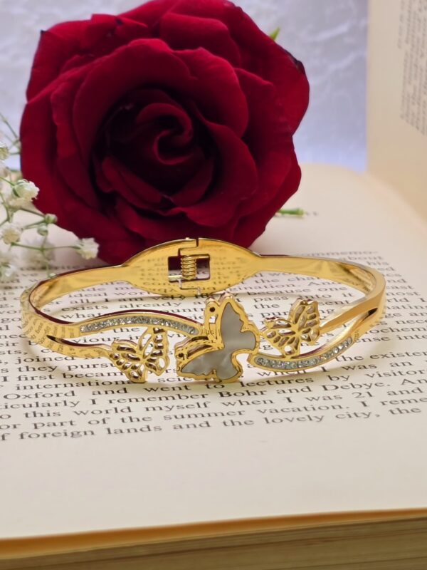 Elegant gold-tone butterfly bangle with crystal accents.